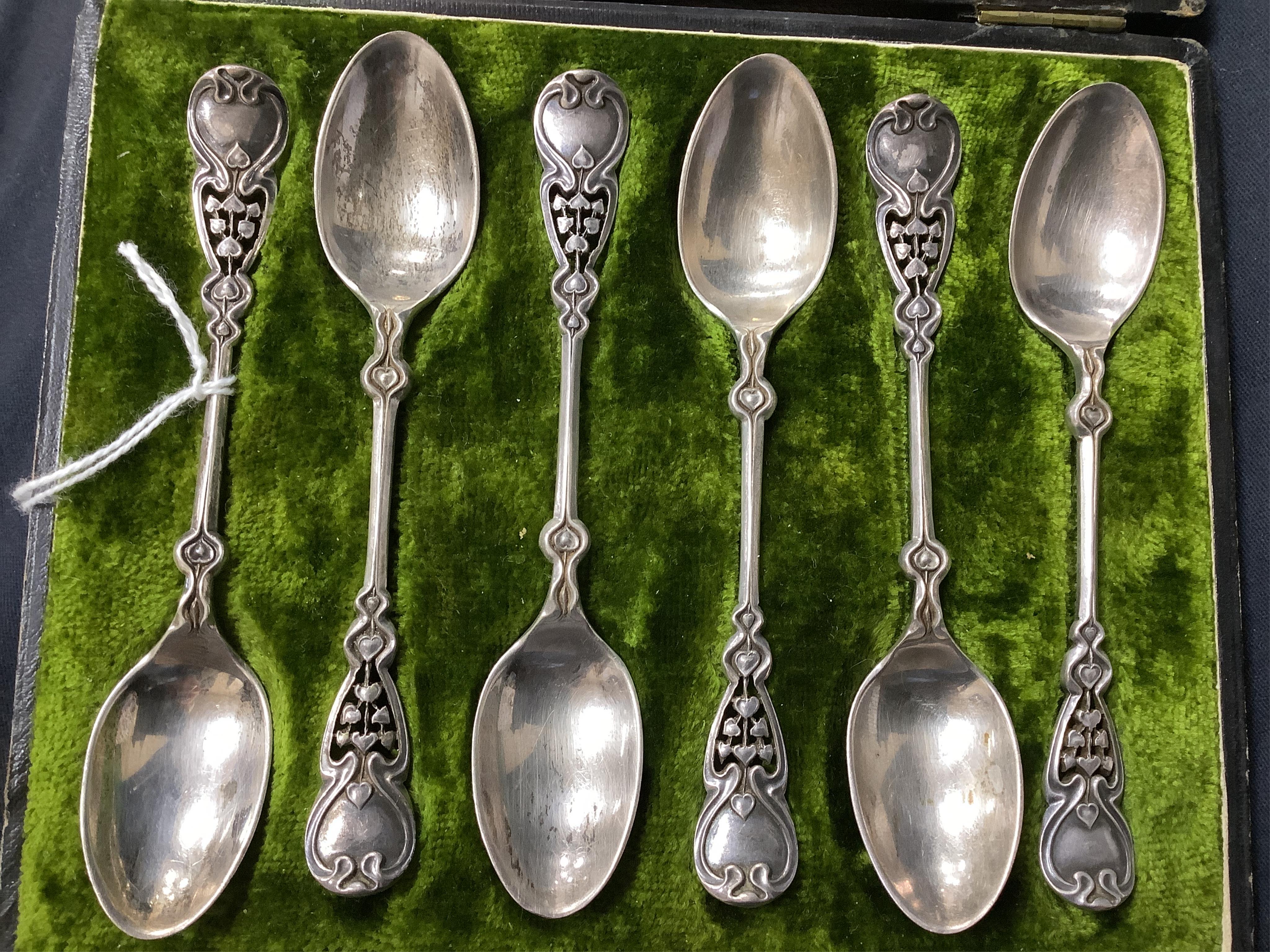 A cased set of six Edwardian Art Nouveau silver coffee spoons, Joseph Rodgers & Sons, Sheffield, 1908, 10.9cm, with pierced stylised terminals.